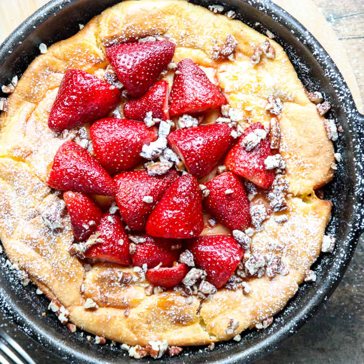 Top shot of baked and filled German pancake in cast iron skillet.