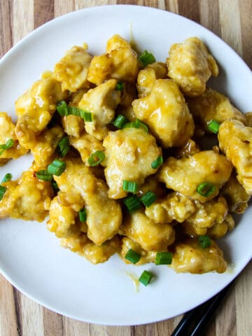 Air fryer orange chicken on a white plate.