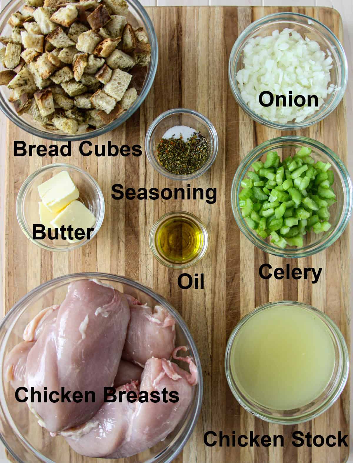 All of the ingredients for this recipe in glass bowls on a wooden board.