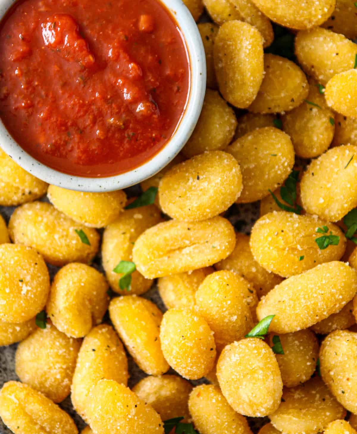 A close overhead shot of air fryer gnocchi.