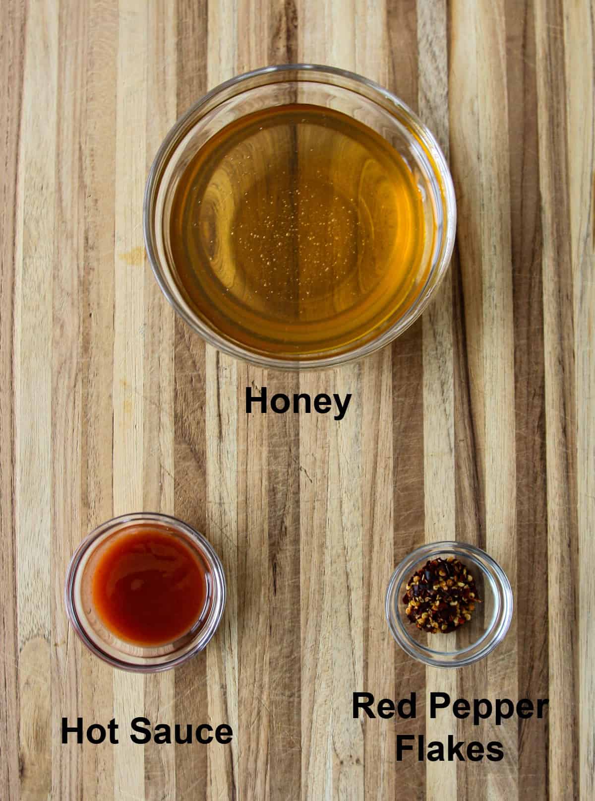 The recipe ingredients in glass bowls on a wooden board.